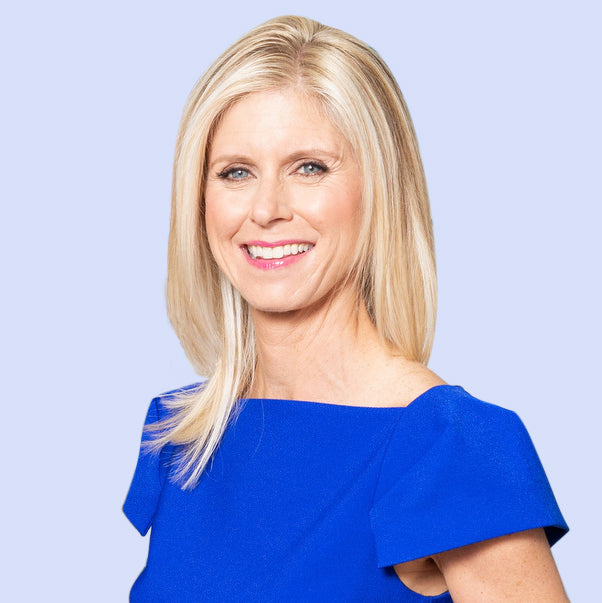 Professional headshot of Marla Beck, CEO of BeautyHealth, wearing a bright blue dress, smiling against a light background.