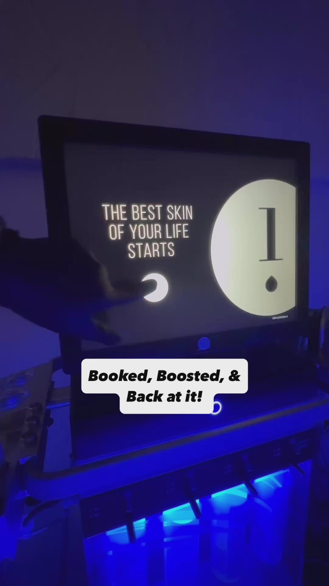 Hydrafacial device lit with a glowing blue light. The screen displays the text “The Best Skin of Your Life Starts” as a hand prepares to begin treatment. Overlay text reads: “Booked, Boosted, & Back at it!”